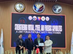 Niero Medina receiving a certificate of recognition at the joint forum for Strengthening Virtual, Cyber, and Forensic Capabilities.