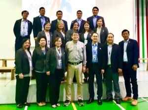 Group photo of government professionals and colleagues from the Office of the Administrator gathered on stage during an anniversary celebration.